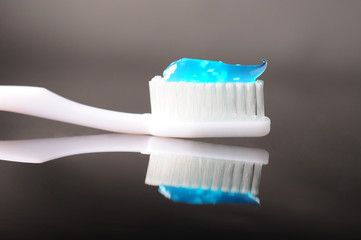 toothbrush with blue toothpaste on it