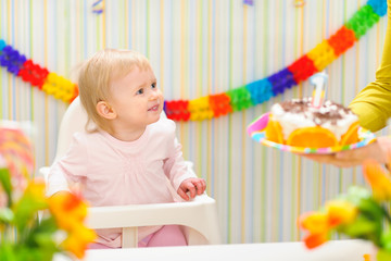 Baby happy to birthday cake