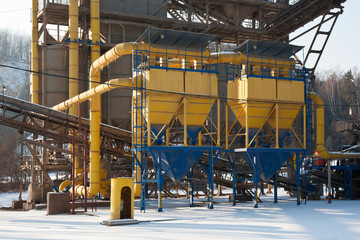 Stone quarry with silos, conveyor belts in winter