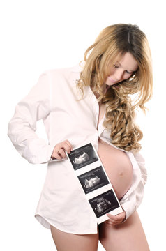 The Pregnant woman holding ultrasound image