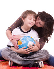 Little schoolboy and mother with globe