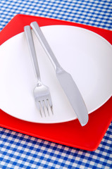 Emtpy plates with utensils on table