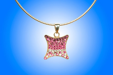 Golden jewellery against gradient background