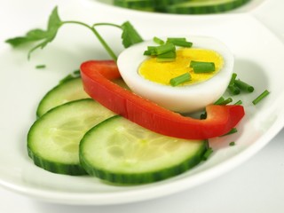 Boiled egg with garnish, close-up.