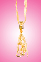 Golden jewellery against gradient background