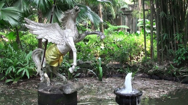 Antique fountain and statue a horse in the deep jungle