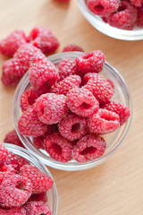 Bowl of raspberries on wooden table