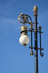 Fototapeta na wymiar Old street lamp next to the Royal Palace of Madrid, Spain