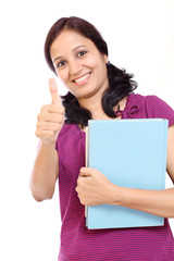Naklejka premium Indian student with her books and showing thumb-up gesture
