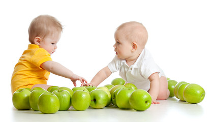 Fototapeta premium Two little children with green apples isolated on white backgrou