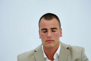 Young manager meditating during pause at work