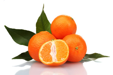 Ripe tasty tangerines with leaves and segments isolated on white