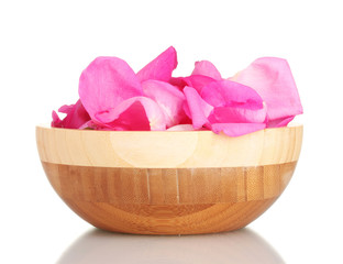 beautiful pink rose petals in wooden bowl isolated on white