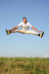 man jumping on green field