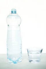 Tuinposter Plastic bottle and Glass of Water © vali_111