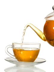 exotic green tea with flowers in glass teapot and cup isolated