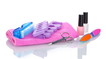 Pedicure set on pink towel isolated on white