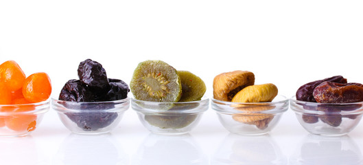 Dried fruits in bowls isolated on white