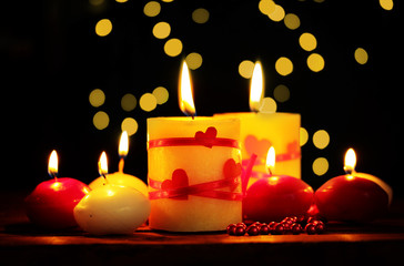 Beautiful candles on wooden table on bright background