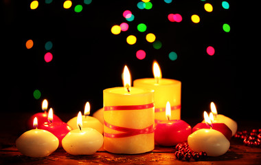 Beautiful candles on wooden table on bright background