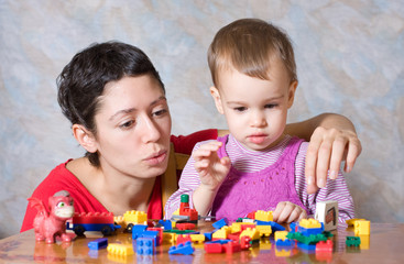 The child in a pink dress with toys