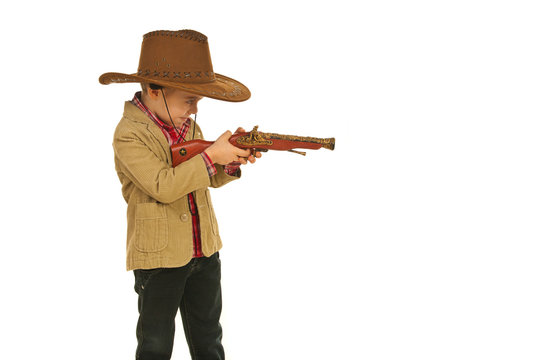 Little cowboy shooting with gun toy