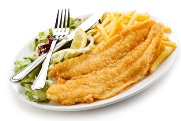 Fish dish - fried fish fillet, French fries with vegetables