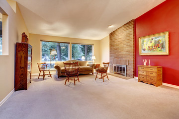 Living room with brick fireplace and carpet.