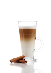 Fragrant сoffee latte in glass cup and cinnamon isolated