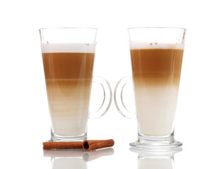 Fragrant сoffee latte in glass cups and cinnamon isolated