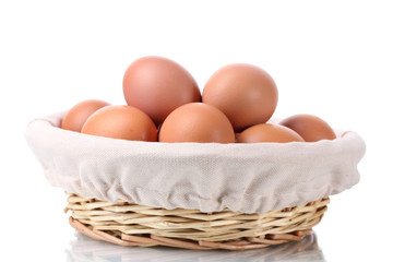brown eggs in basket isolated on white