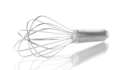 Metal whisk for whipping eggs isolated on white