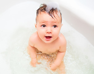 Little baby splashing in bath