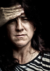 Grunge image of a very stressed woman