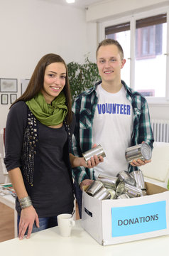 young volunteer couple with food donation box