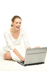 Woman sitting in bed with laptop