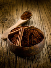 cacao powder with cinnamon on wood bowl