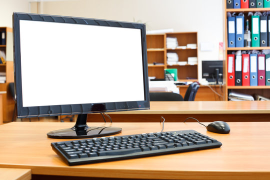 Modern personal computer on desktop in office room