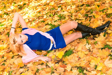 young woman resting on the maple leaves