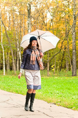 young woman with umbrella in park