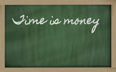 expression -  Time is money - written on a school blackboard wit