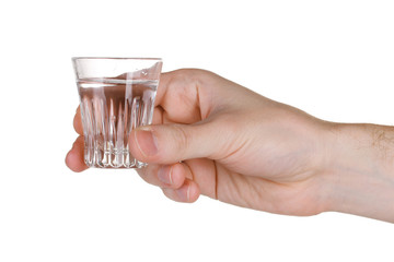 Man's hand holding a glass with vodka isolated on white