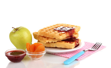 Tasty waffles with jam on plate isolated on white