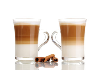 Fragrant сoffee latte in glass cups and cinnamon isolated