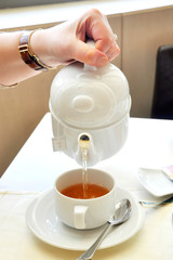 Woman's hand pouring tea