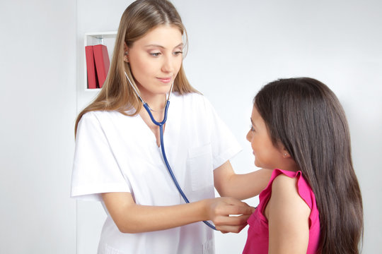 Doctor Examining Child in Clinic