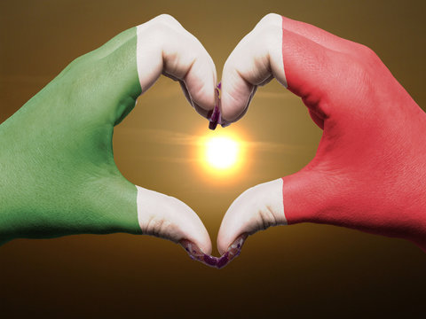 Heart and love gesture by hands colored in italy flag during bea