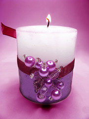 pink scented candle on dark background