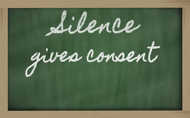 Obraz premium expression - Silence gives consent - written on a school blackb