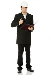 Young engineer in white helmet gesturing OK